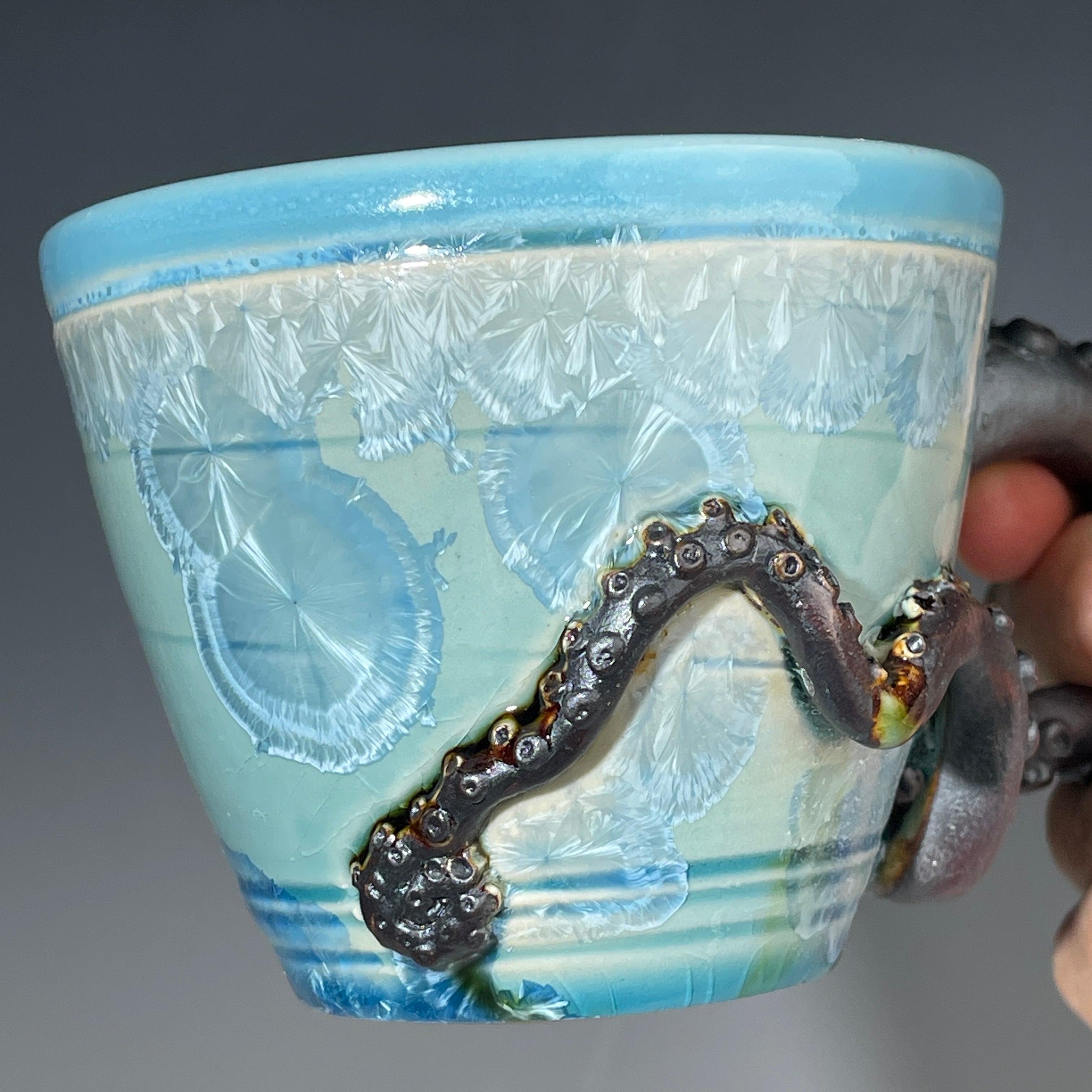 sky blue crystalline glazed cup with octopus tentacle handle by Adam & Hong Rubinstein