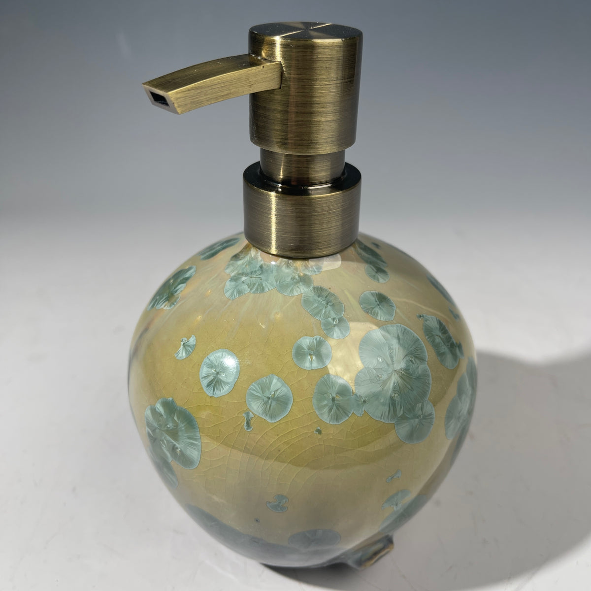 handmade soap dispenser with amazing crystalline formations in the glaze in green hues