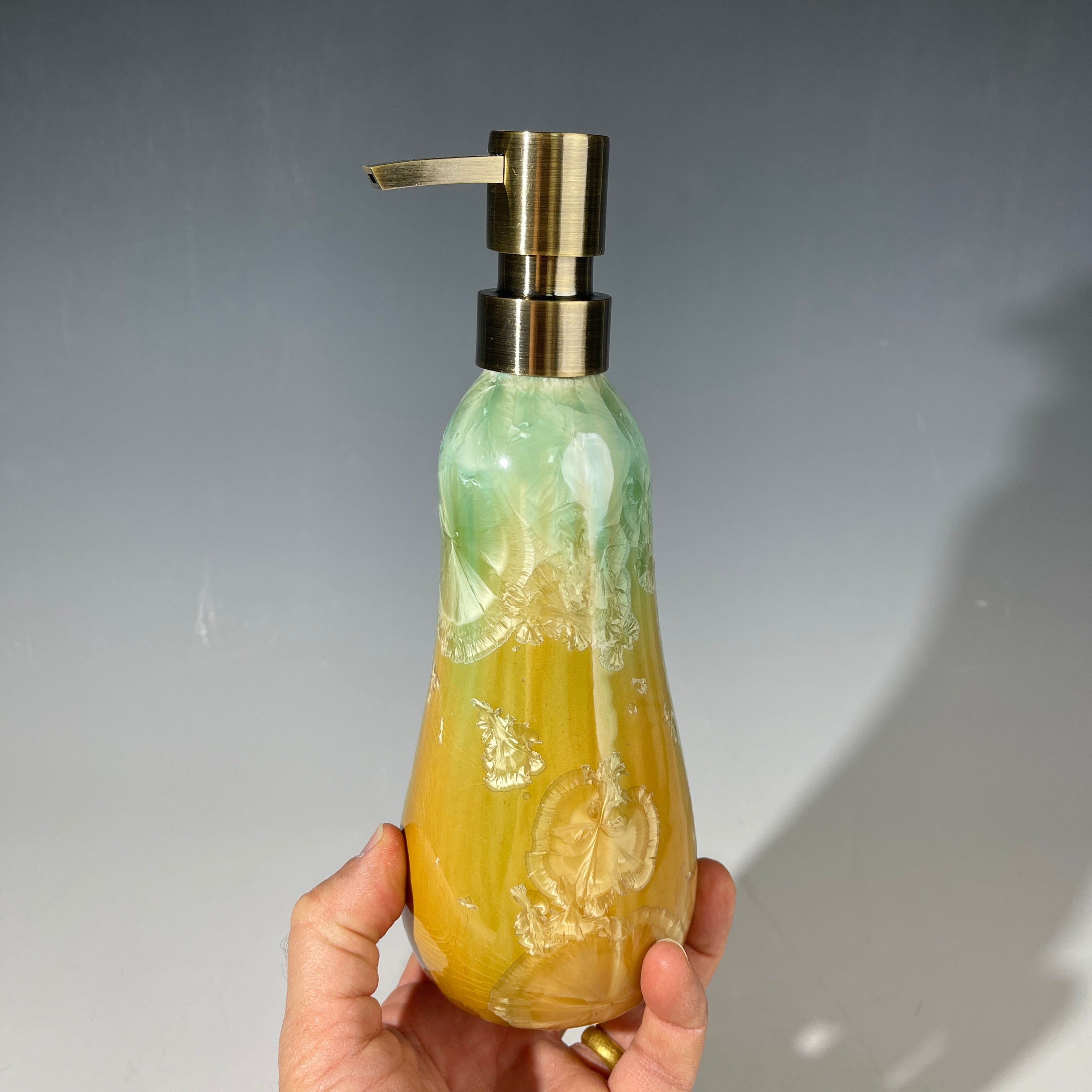 artistic soap dispenser in aqua fade to golden sunrise toned crystalline glaze