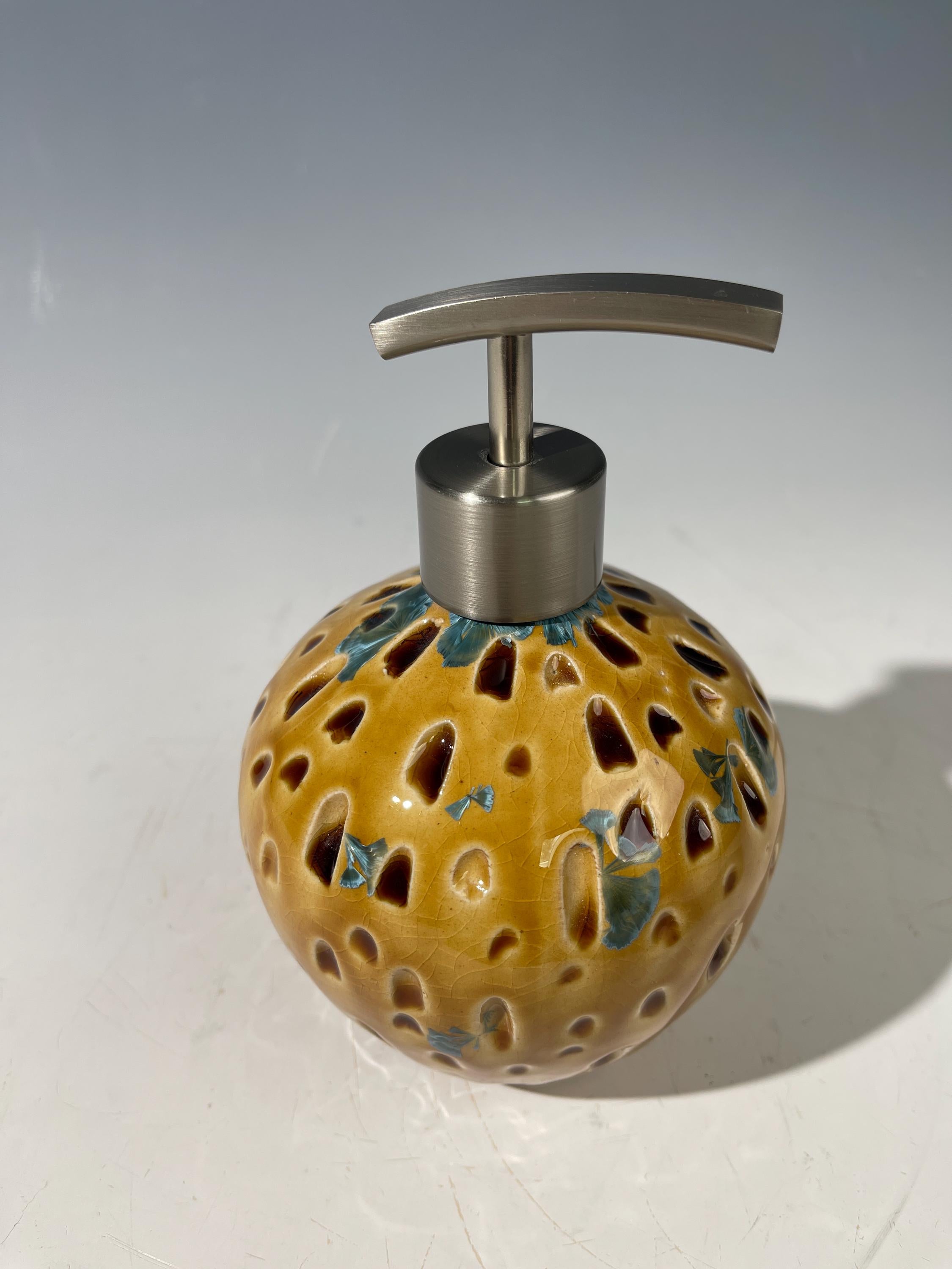 Soap and lotion pump sculptural crystalline golden  metropolis high rise window.