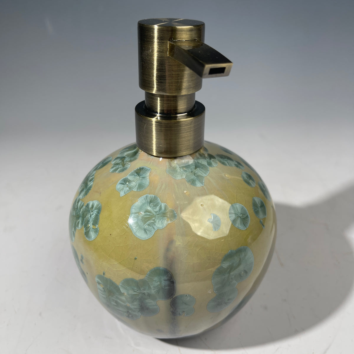 handmade soap dispenser with amazing crystalline formations in the glaze in green hues