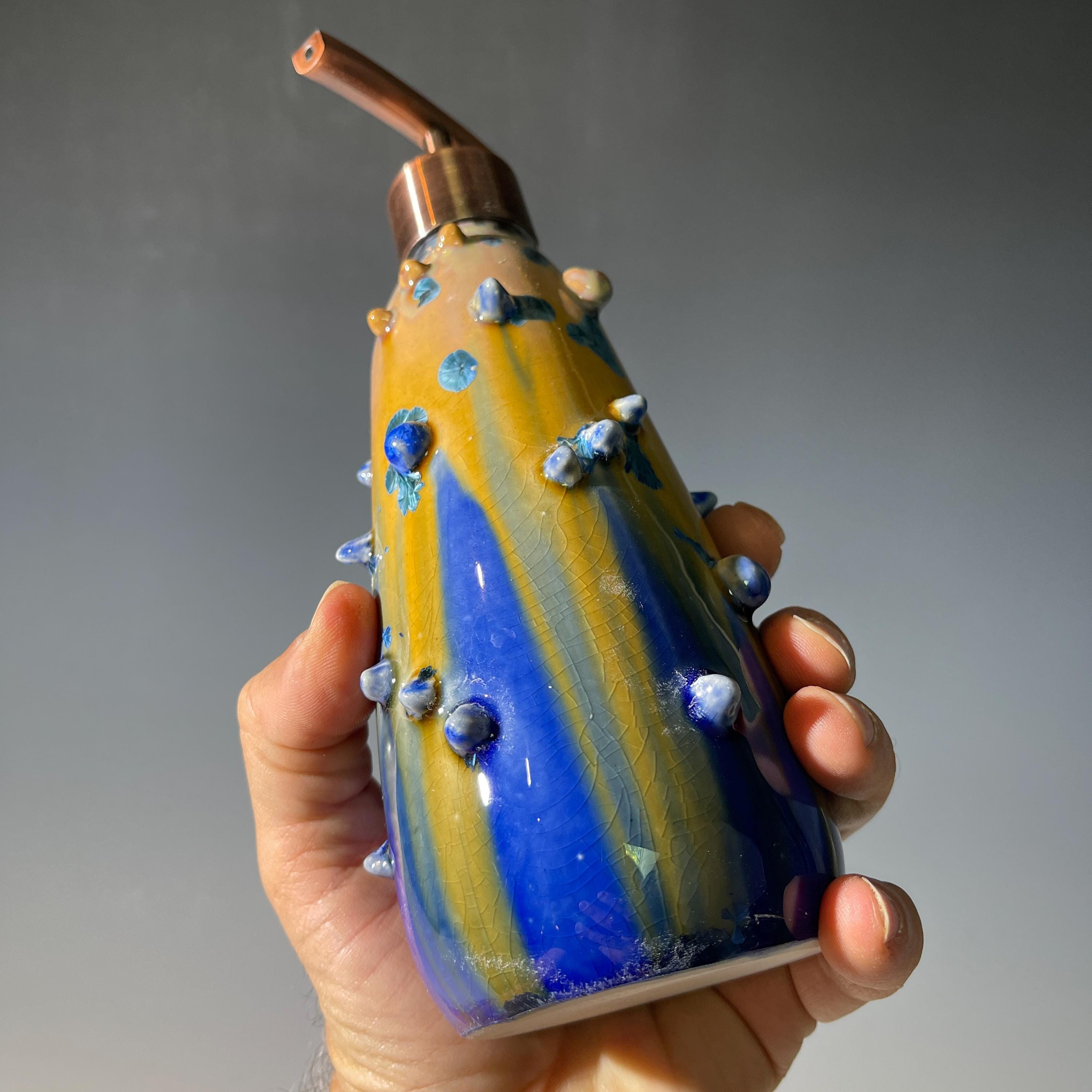 A refractive spiny orange dreams of blue soap pump soap or lotion dispenser