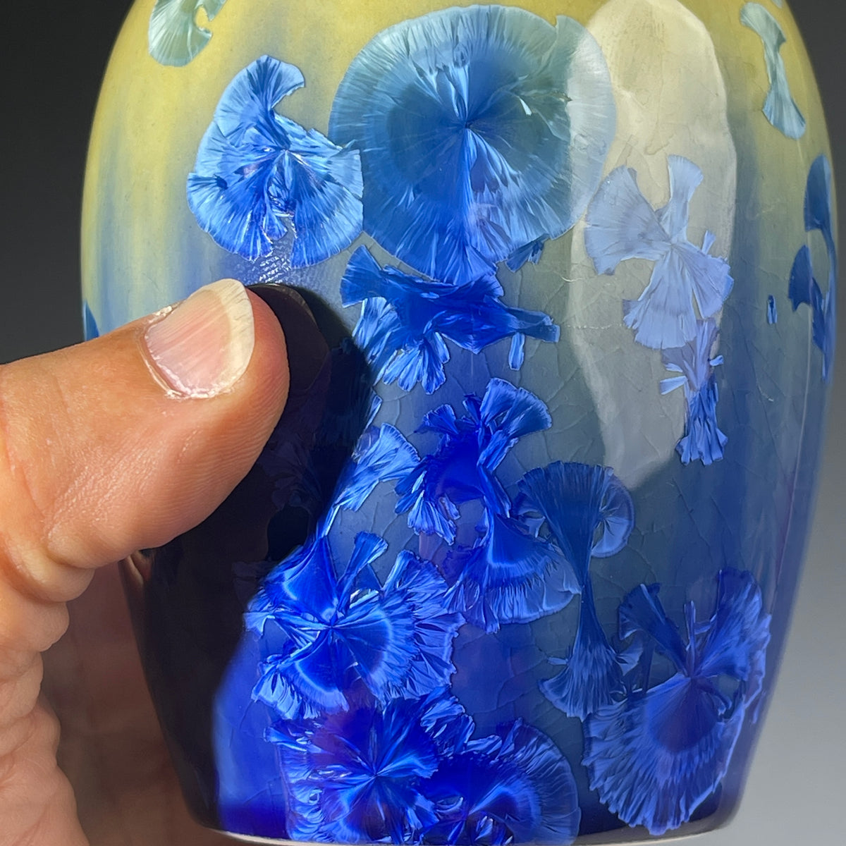 chartreuse to cobalt crystalline glazed soap dispenser close up of crystalline structure of glaze
