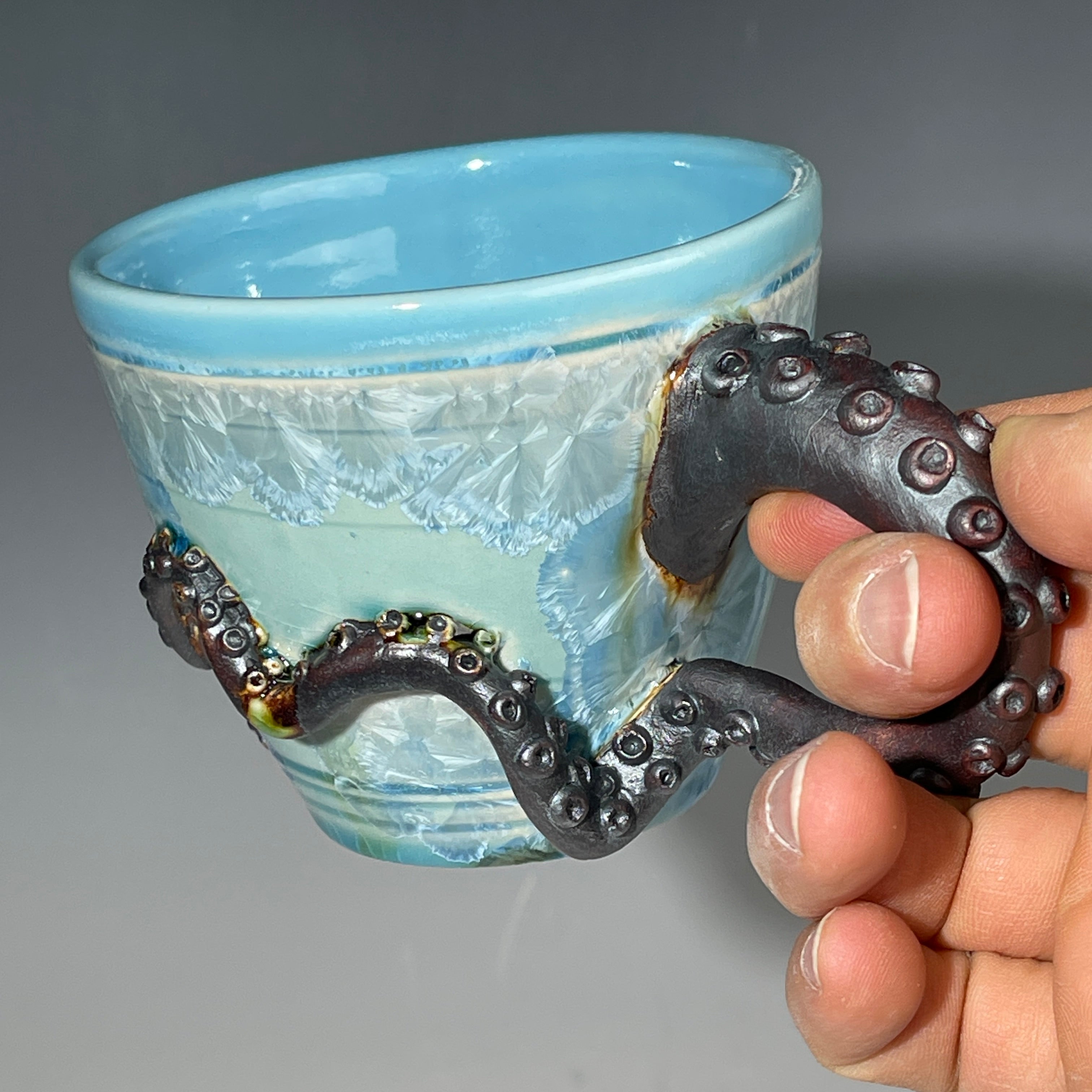 sky blue crystalline glazed cup with octopus tentacle handle by Adam & Hong Rubinstein