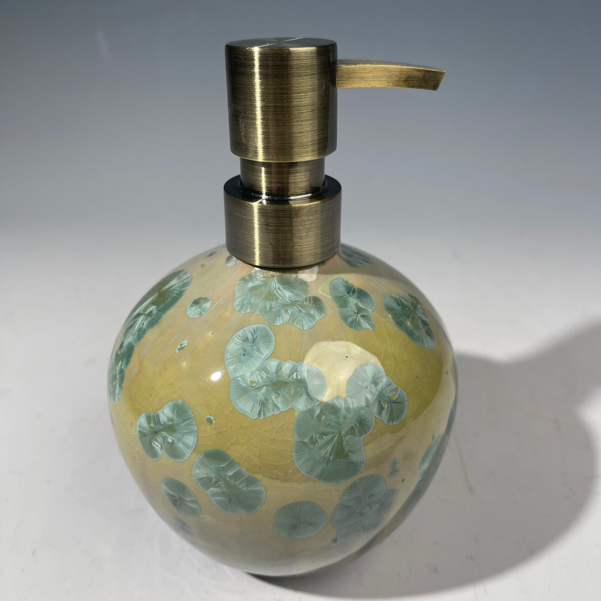 handmade soap dispenser with amazing crystalline formations in the glaze in green hues