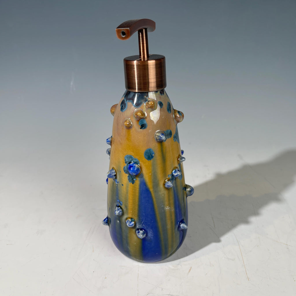 A refractive spiny orange dreams of blue soap pump soap or lotion dispenser