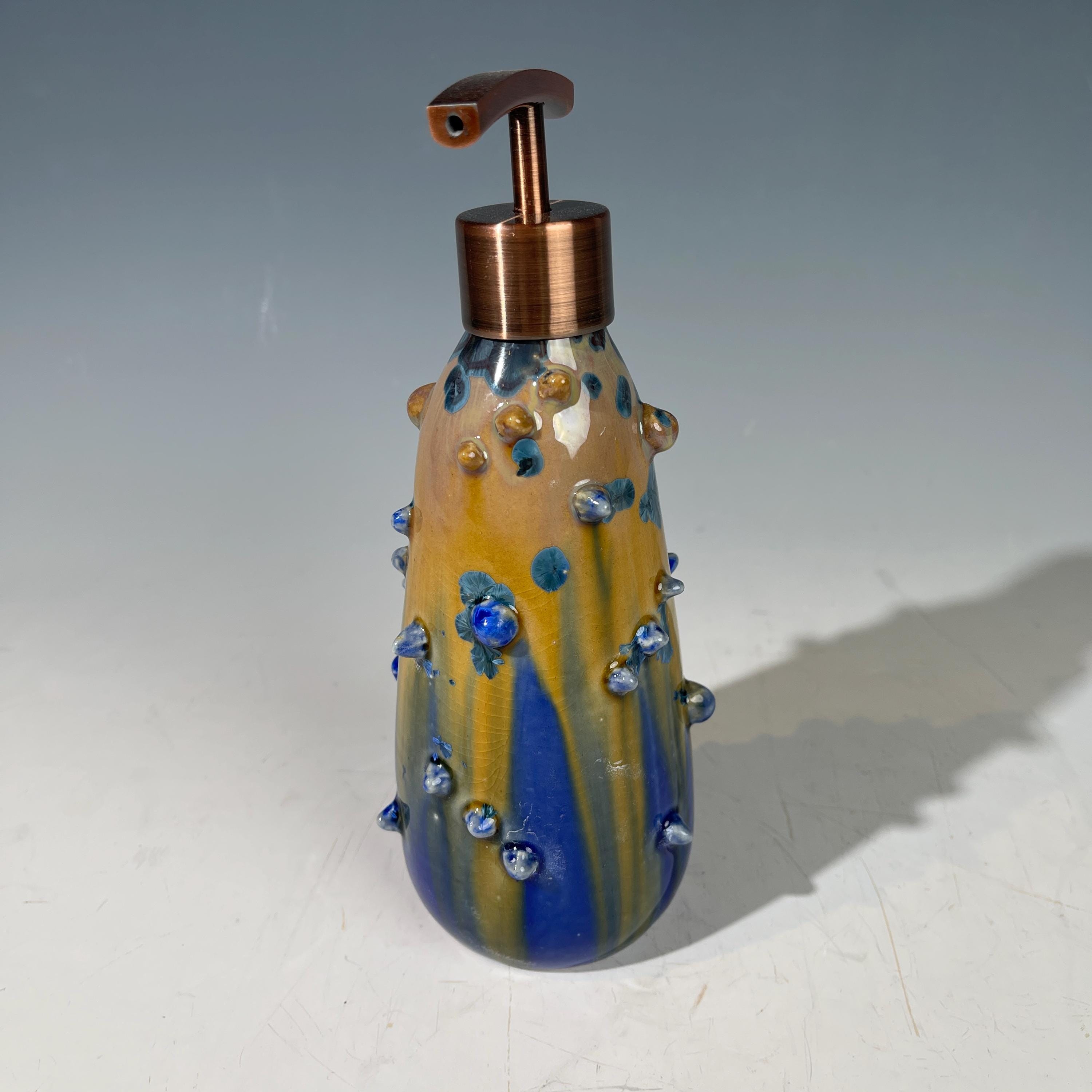A refractive spiny orange dreams of blue soap pump soap or lotion dispenser