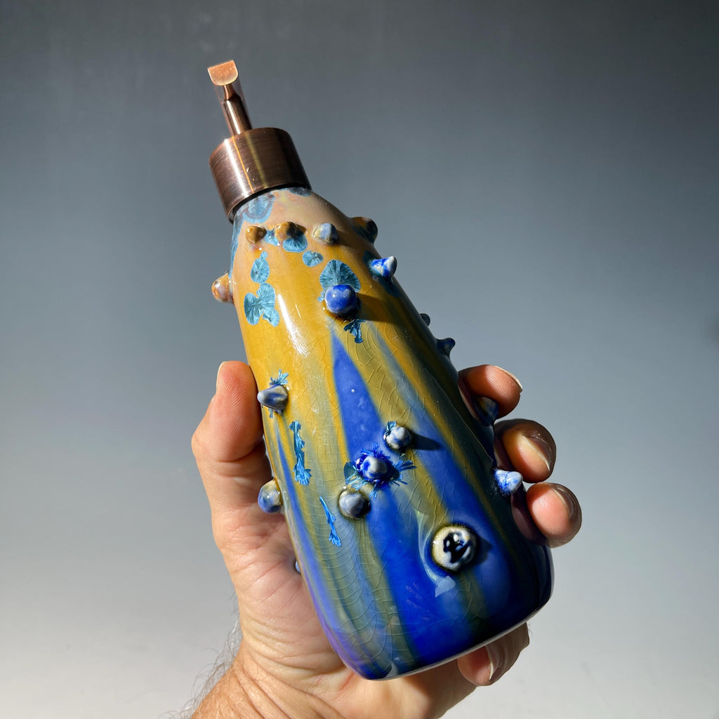 A refractive spiny orange dreams of blue soap pump soap or lotion dispenser