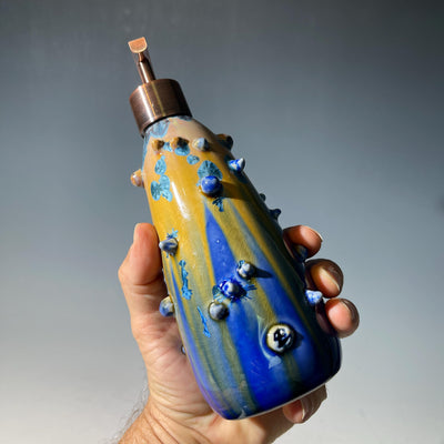 A refractive spiny orange dreams of blue soap pump soap or lotion dispenser