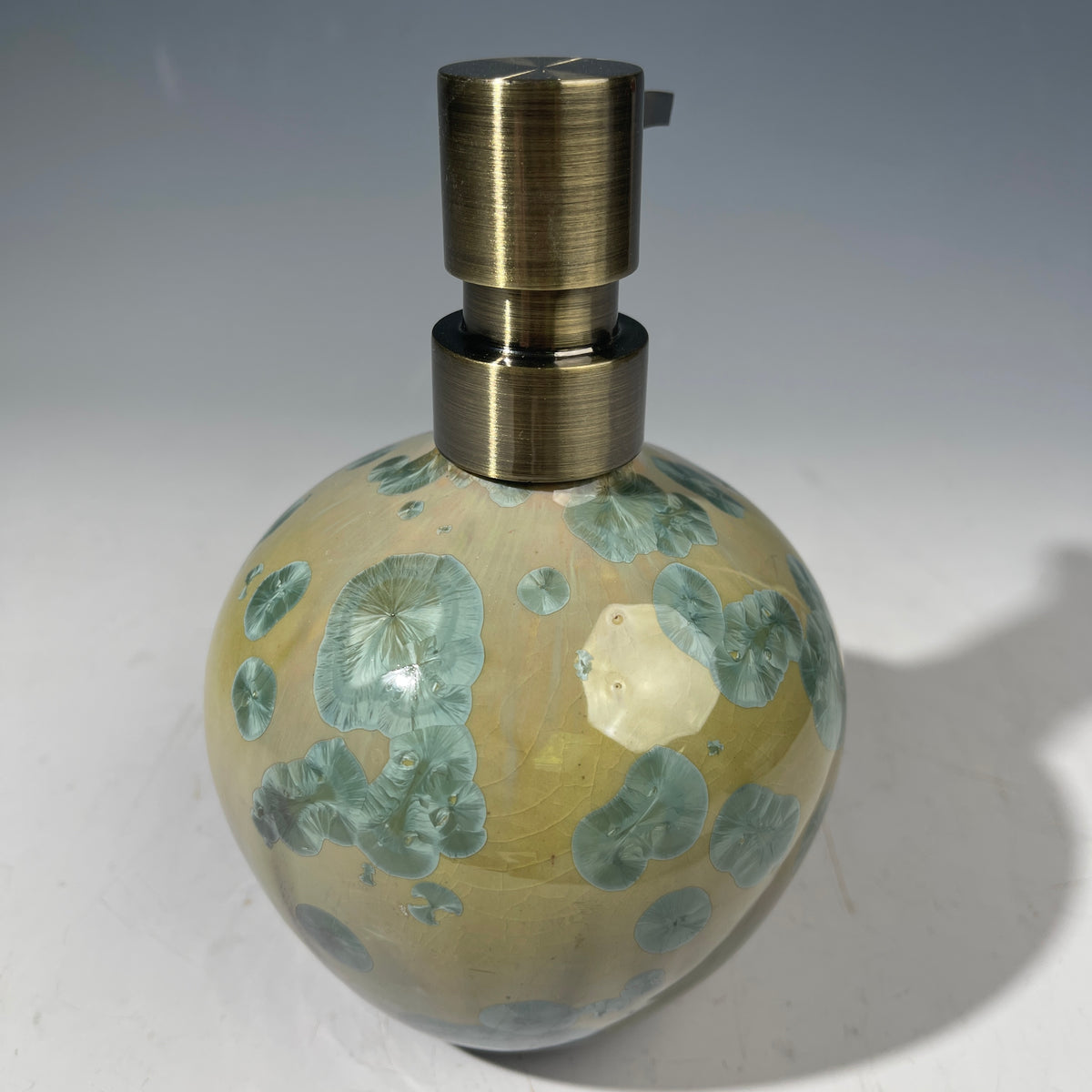 handmade soap dispenser with amazing crystalline formations in the glaze in green hues