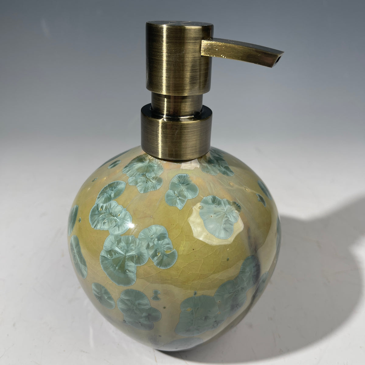 handmade soap dispenser with amazing crystalline formations in the glaze in green hues