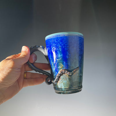 Octopus tentacled mug in deep ocean blue with sparkling crystals by Hong & Adam Rubinstein