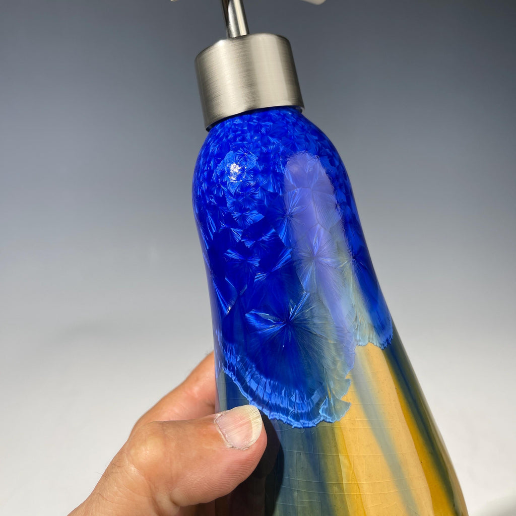 A refractive orange dreams of blue soap pump soap or lotion dispenser