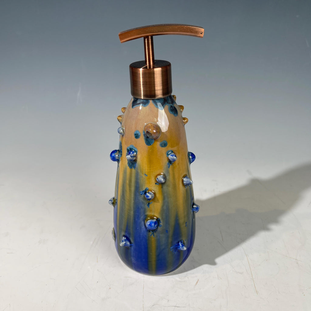 A refractive spiny orange dreams of blue soap pump soap or lotion dispenser