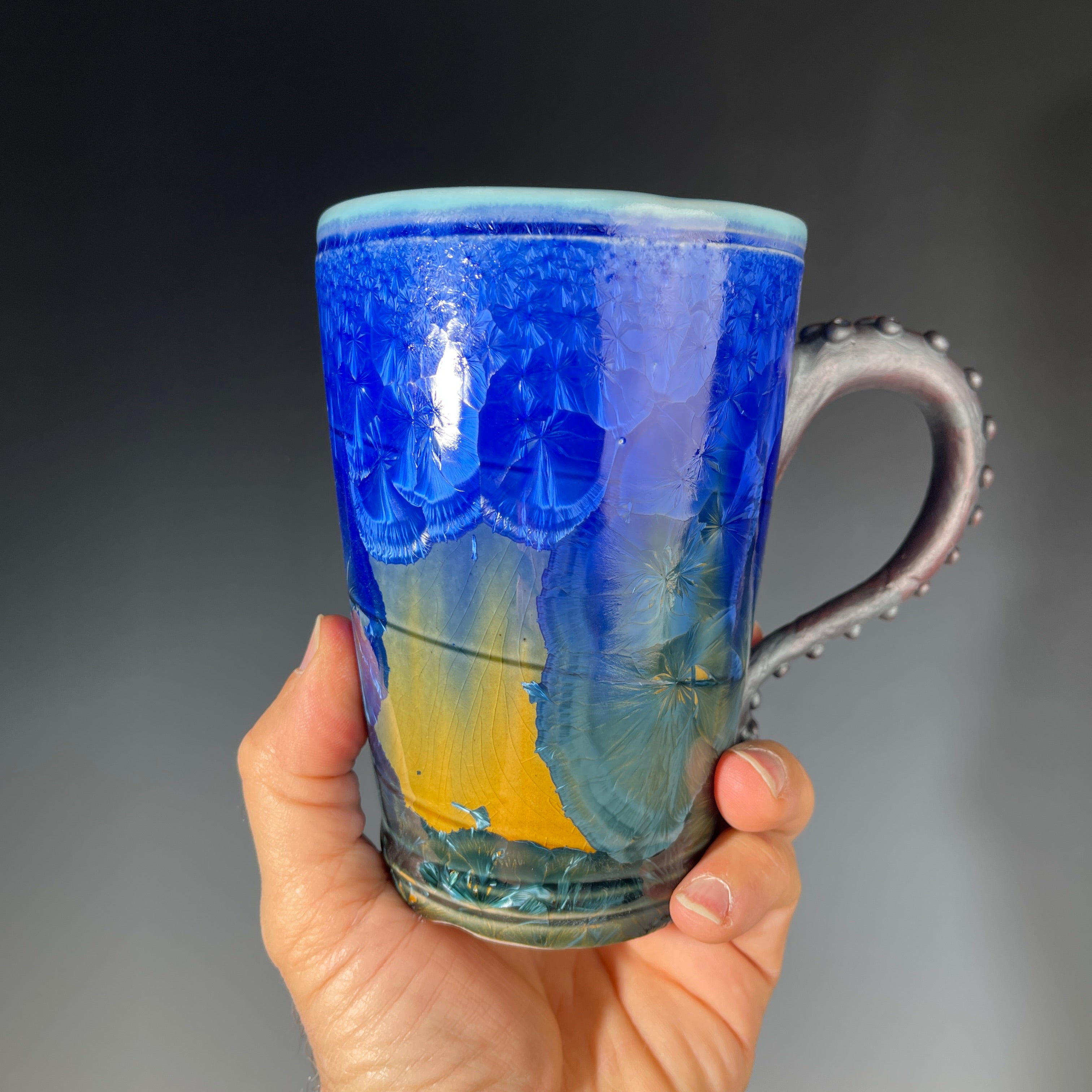 Octopus tentacled mug in deep ocean blue with sparkling crystals by Hong & Adam Rubinstein