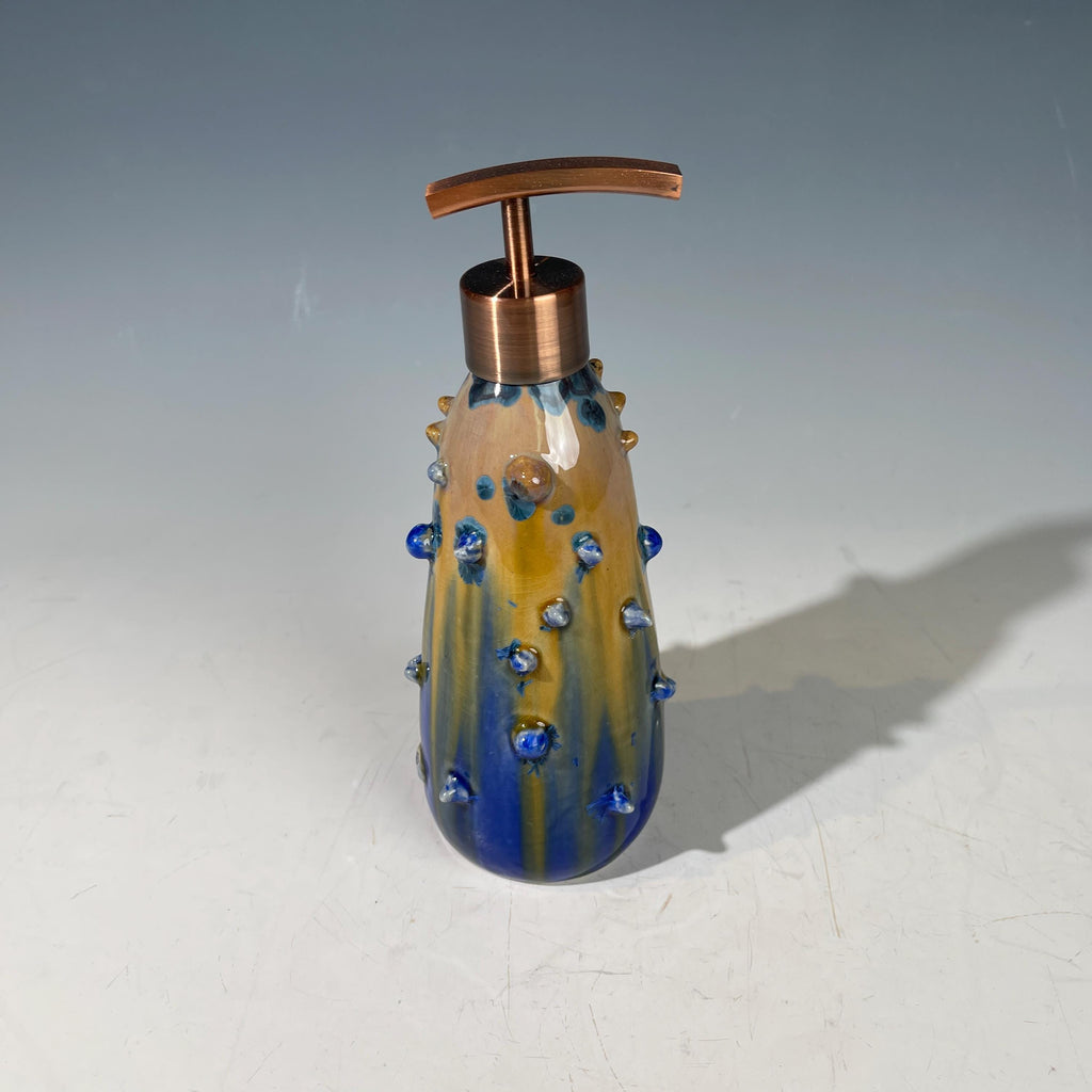 A refractive spiny orange dreams of blue soap pump soap or lotion dispenser