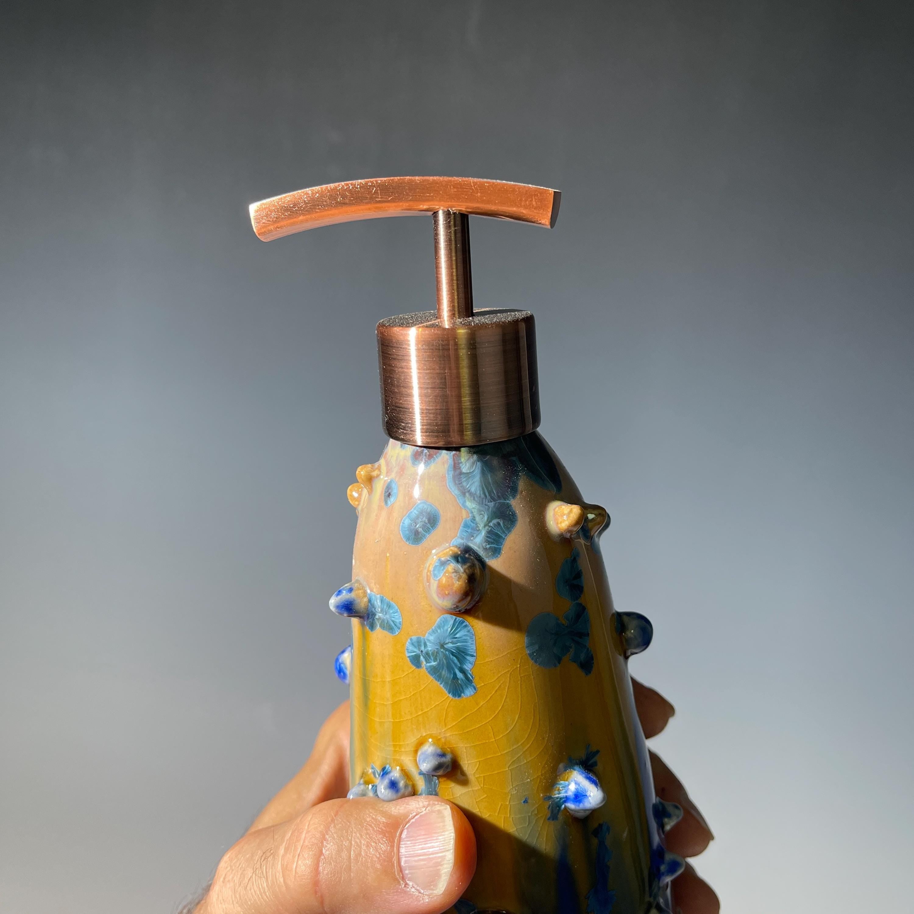 A refractive spiny orange dreams of blue soap pump soap or lotion dispenser