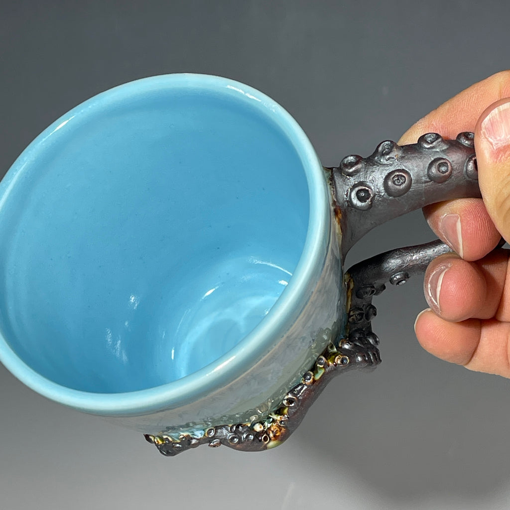 sky blue crystalline glazed cup with octopus tentacle handle by Adam & Hong Rubinstein