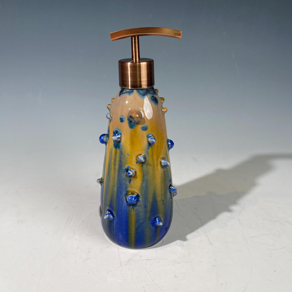 A refractive spiny orange dreams of blue soap pump soap or lotion dispenser