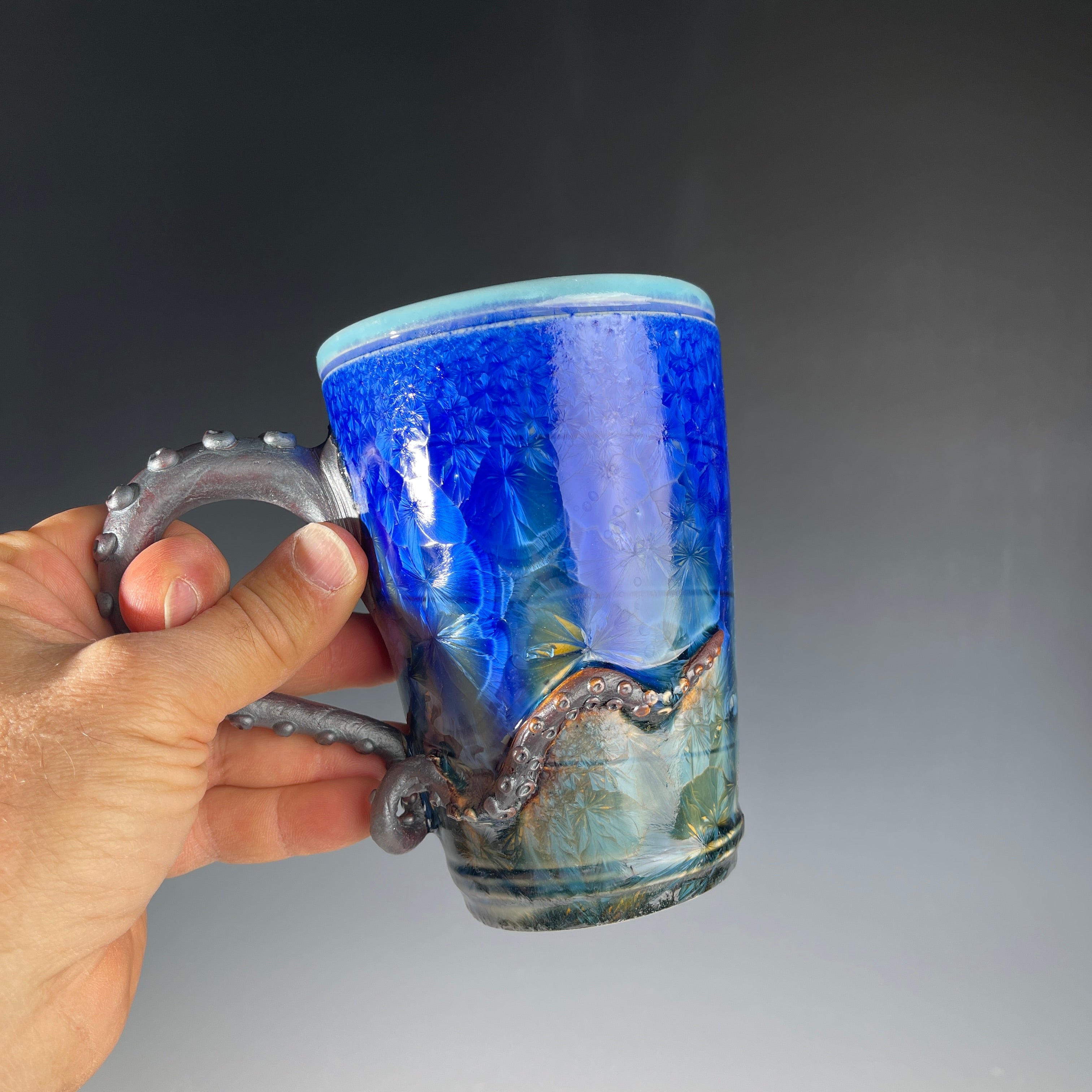 Octopus tentacled mug in deep ocean blue with sparkling crystals by Hong & Adam Rubinstein