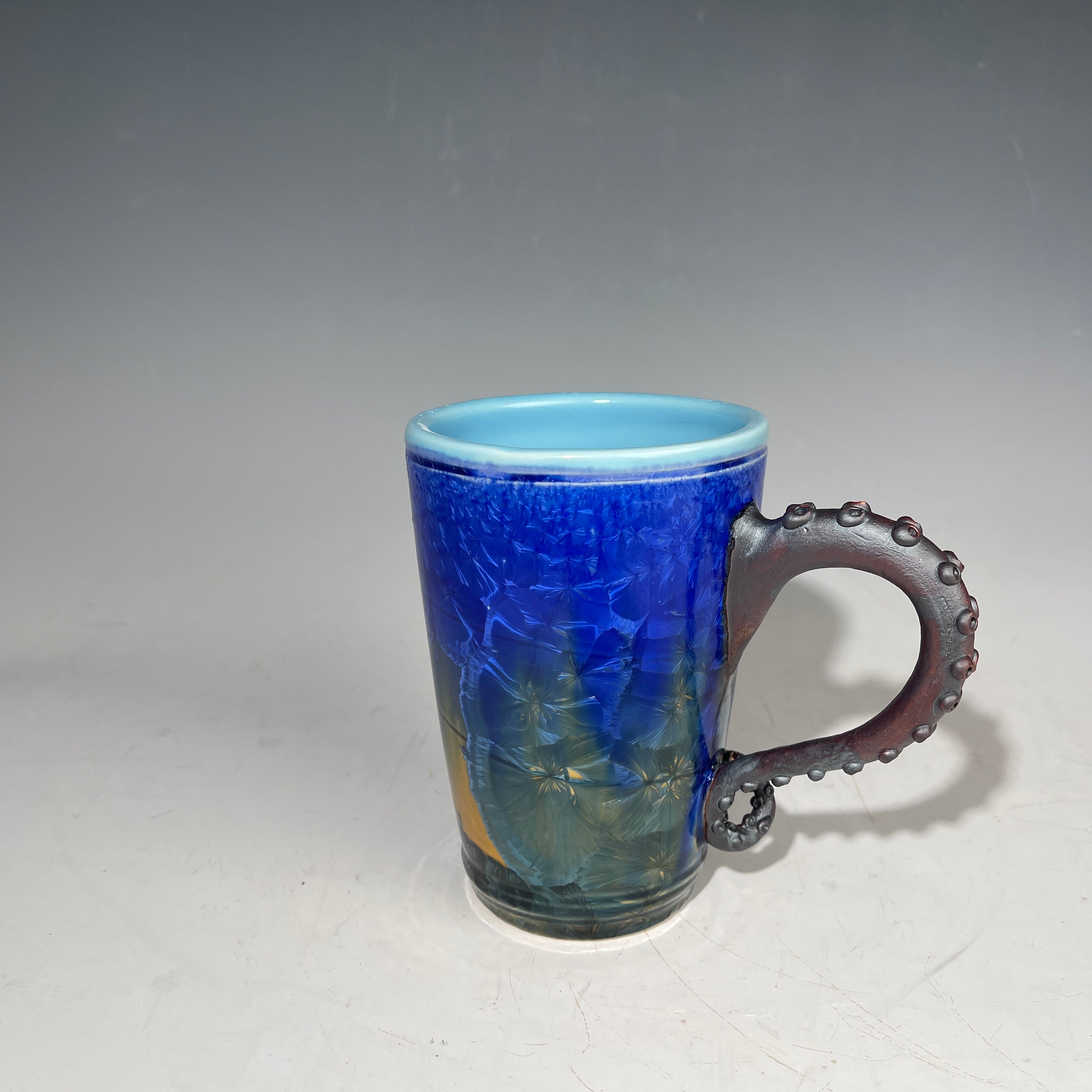 Octopus tentacle mug in cobalt macro crystalline glaze by Adam & Hong Rubinstein 