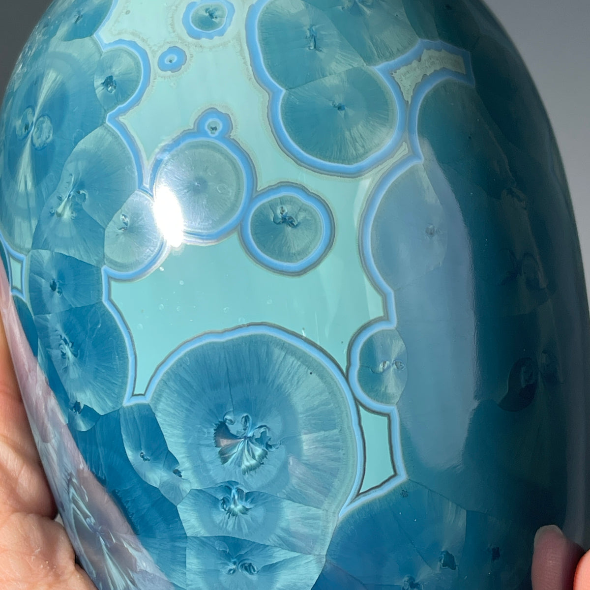  close up of a unique art soap dispenser by Hong Rubinstein in an ocean hued sparkling refractive  macro crystalline glaze
