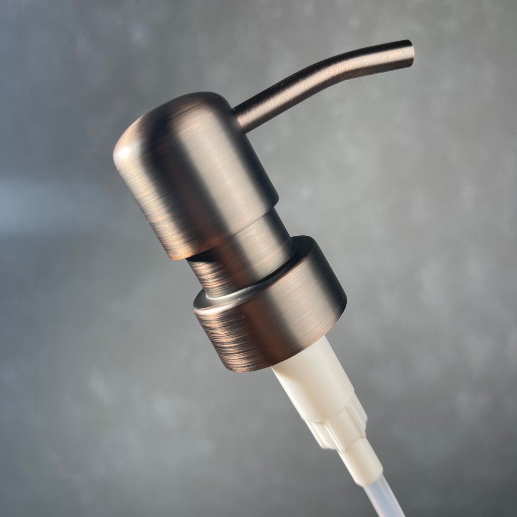 Bronze soap dispenser on a gray background