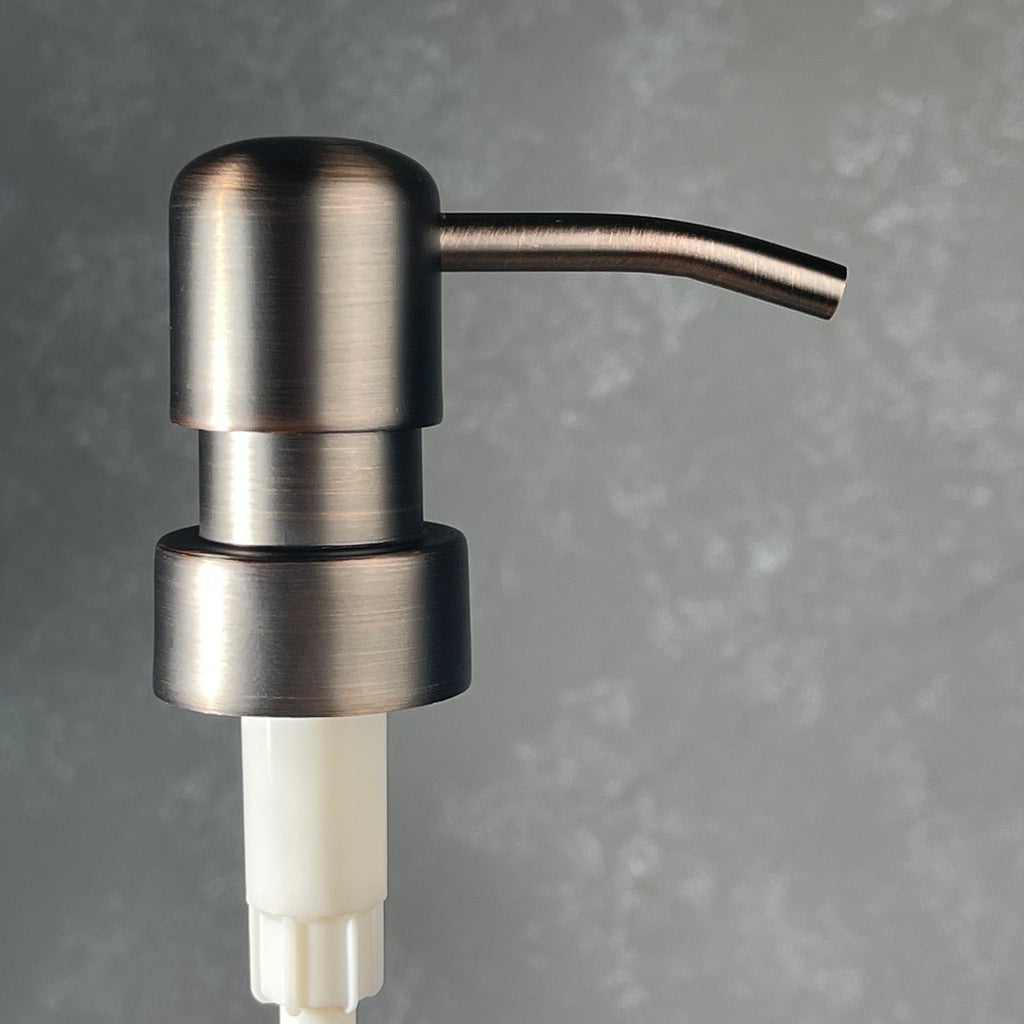 Bronze soap dispenser on a gray background