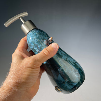 soap dispenser in shimmering  teal macro crystalline glaze with sculptural elements in iron tones