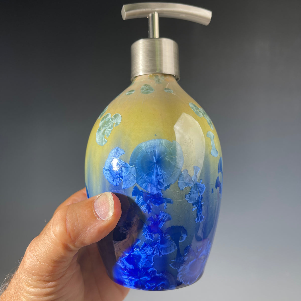 chartreuse to cobalt crystalline glazed soap dispenser in hand