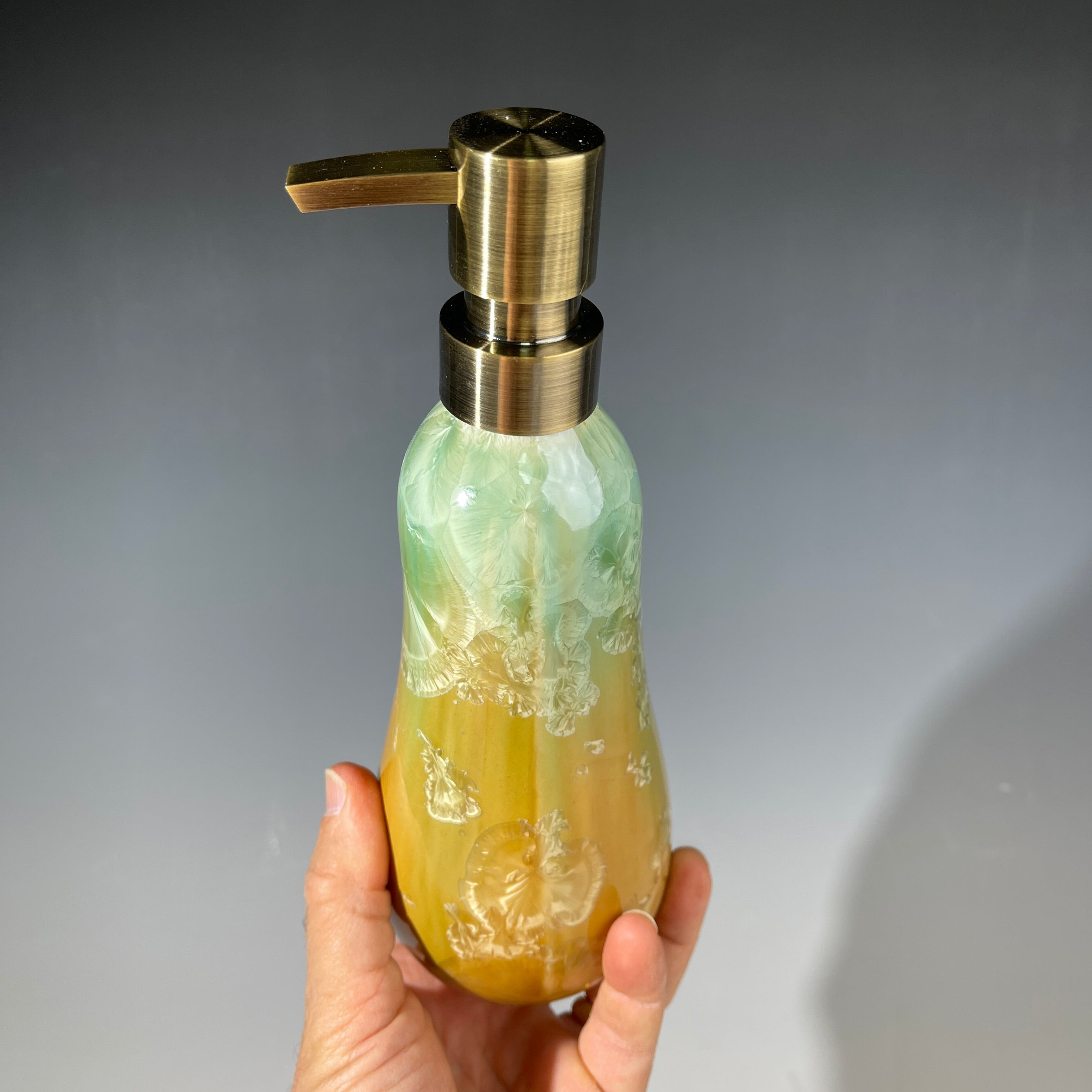 artistic soap dispenser in aqua fade to golden sunrise toned crystalline glaze