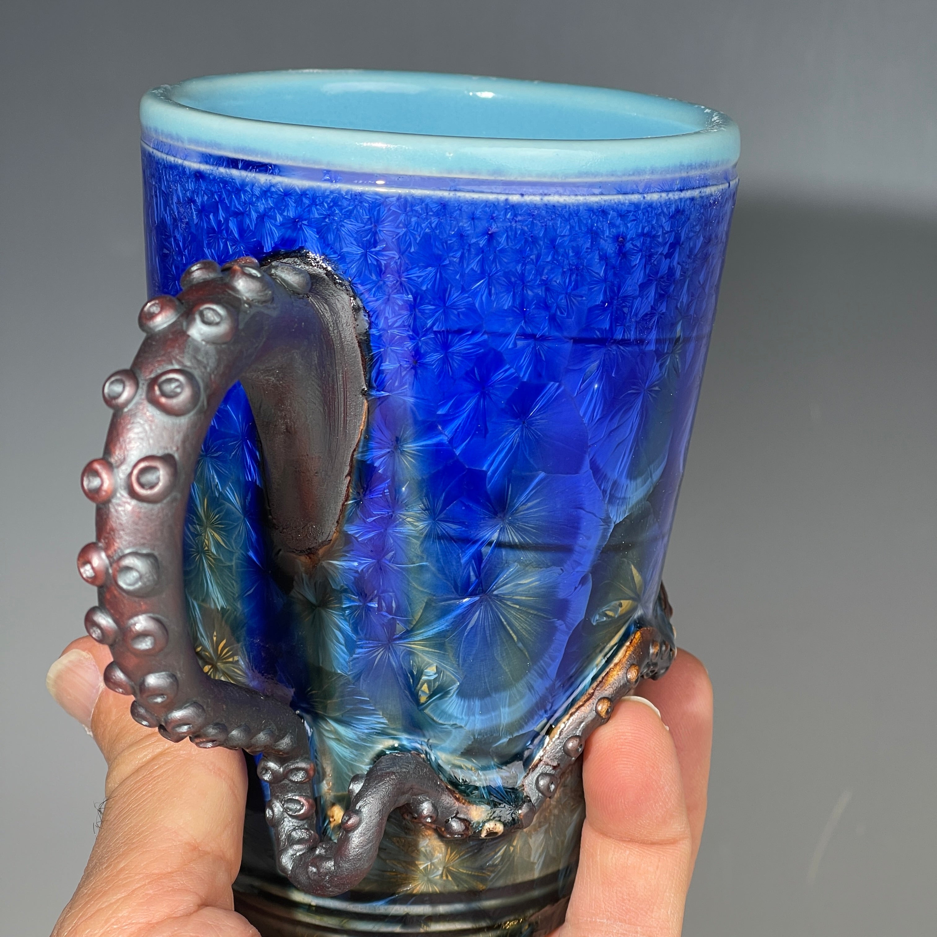 Octopus tentacle mug in cobalt macro crystalline glaze by Adam & Hong Rubinstein 