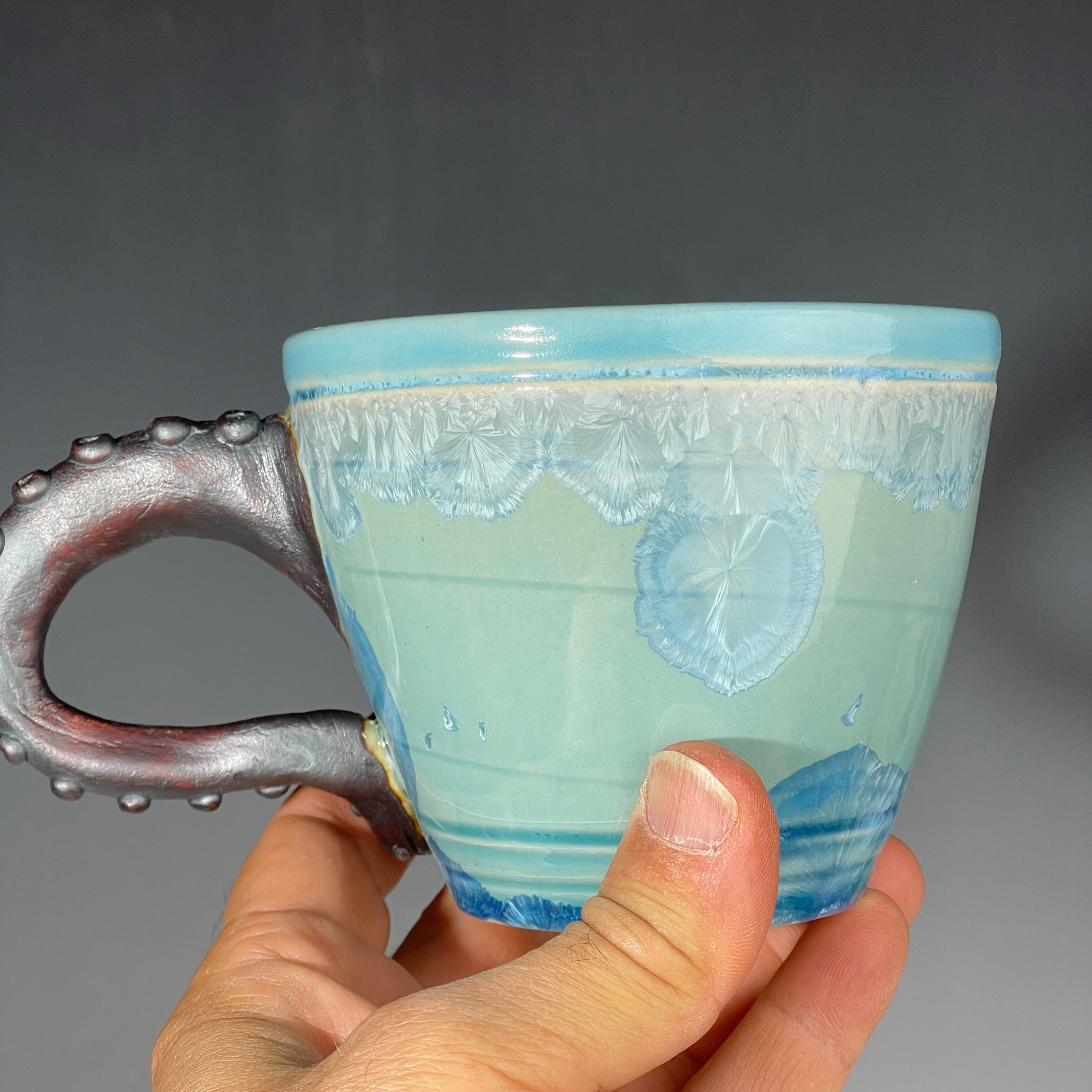 sky blue crystalline glazed cup with octopus tentacle handle by Adam & Hong Rubinstein