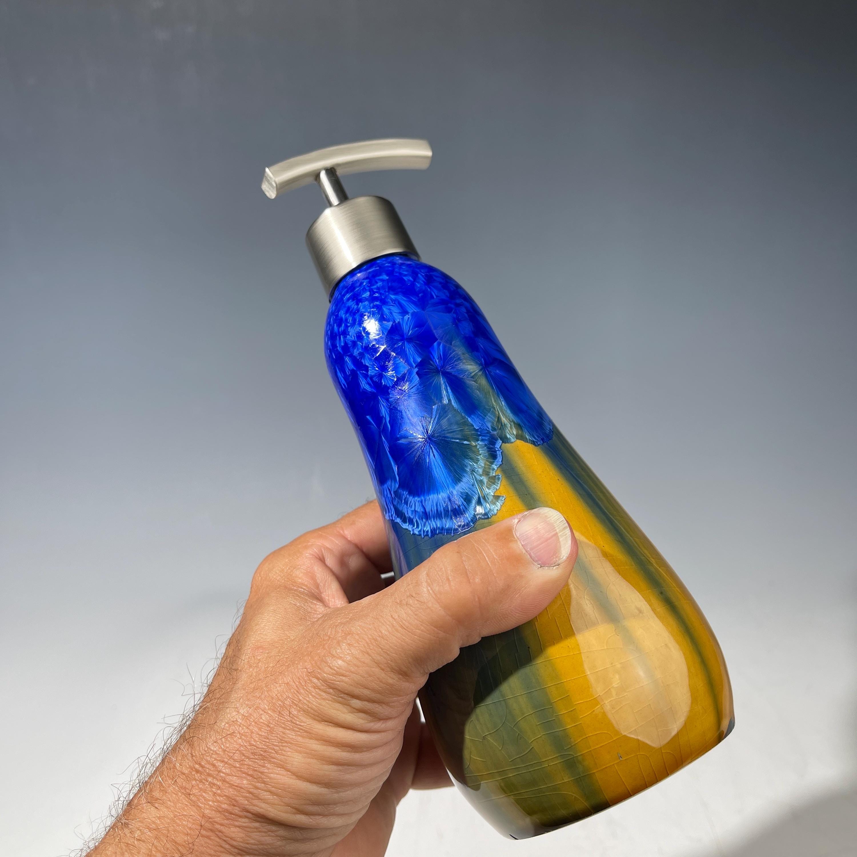 A refractive orange dreams of blue soap pump soap or lotion dispenser