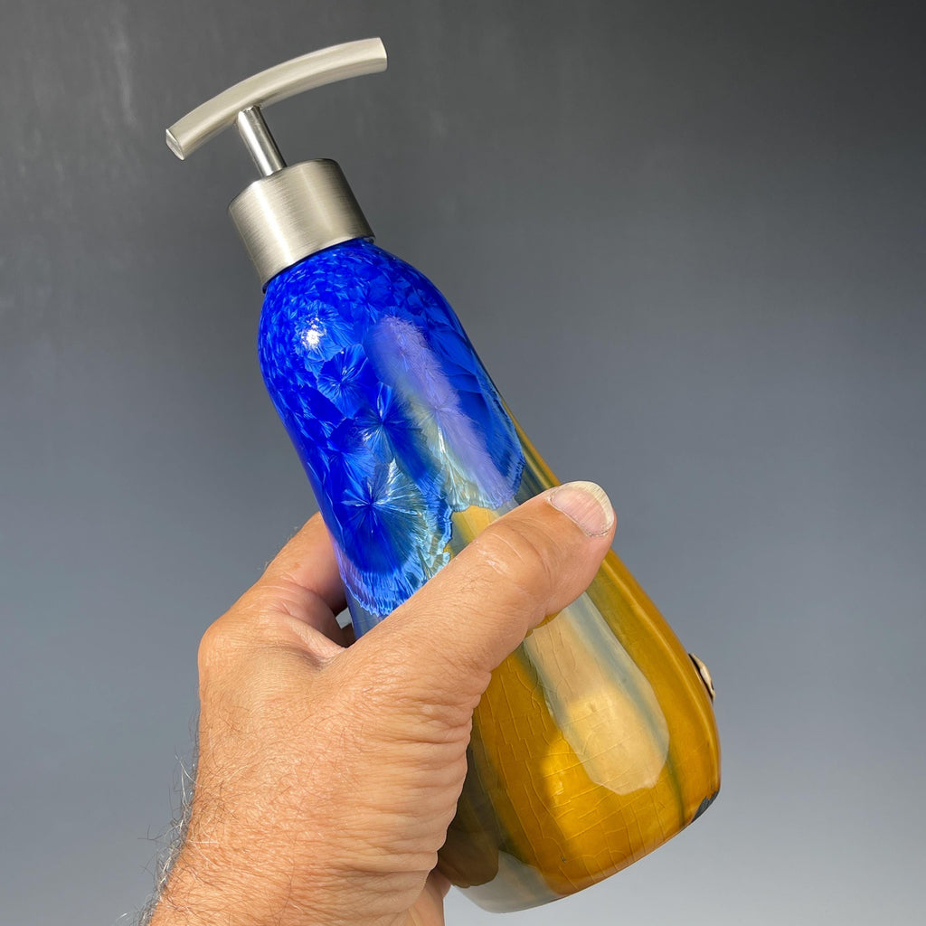 A refractive orange dreams of blue soap pump soap or lotion dispenser