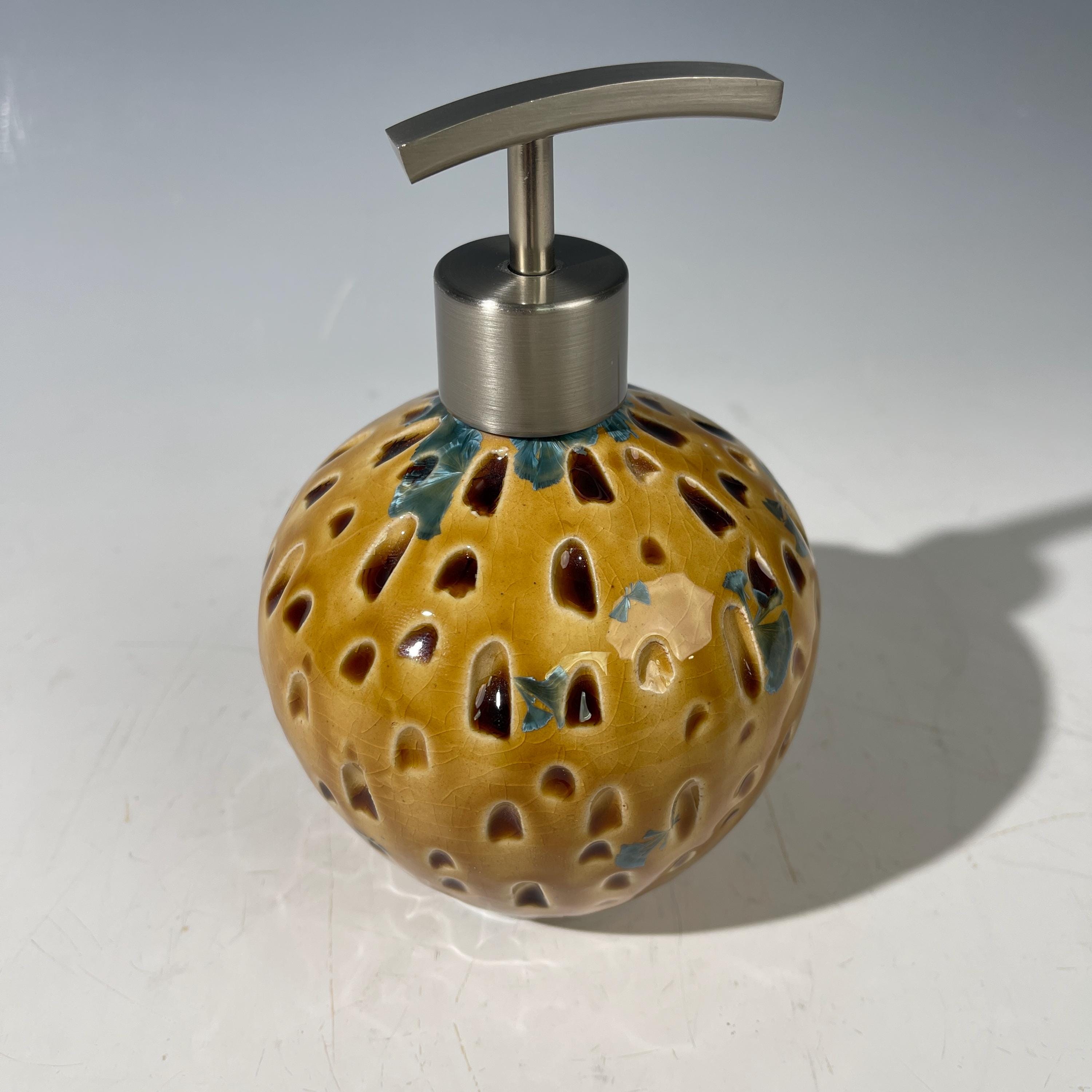 Soap and lotion pump sculptural crystalline golden  metropolis high rise window.