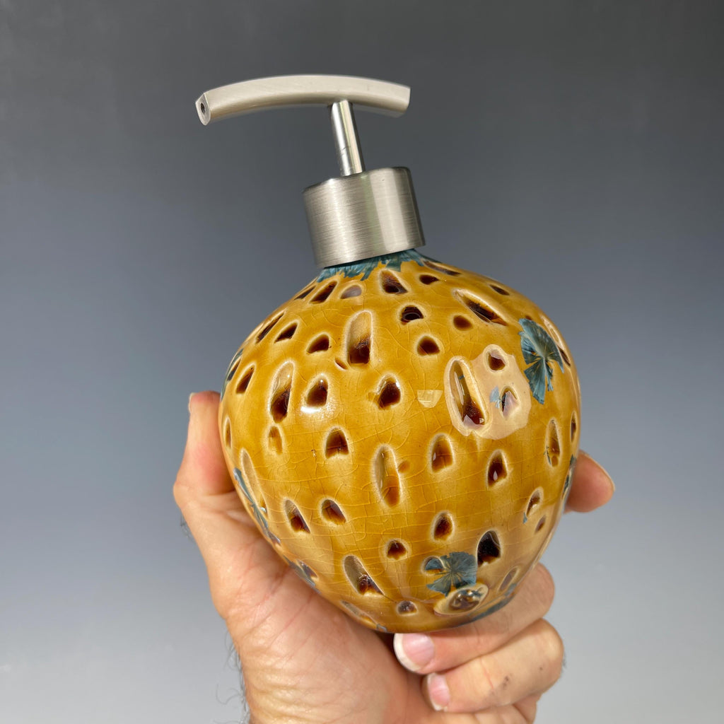 Soap and lotion pump sculptural crystalline golden  metropolis high rise window.