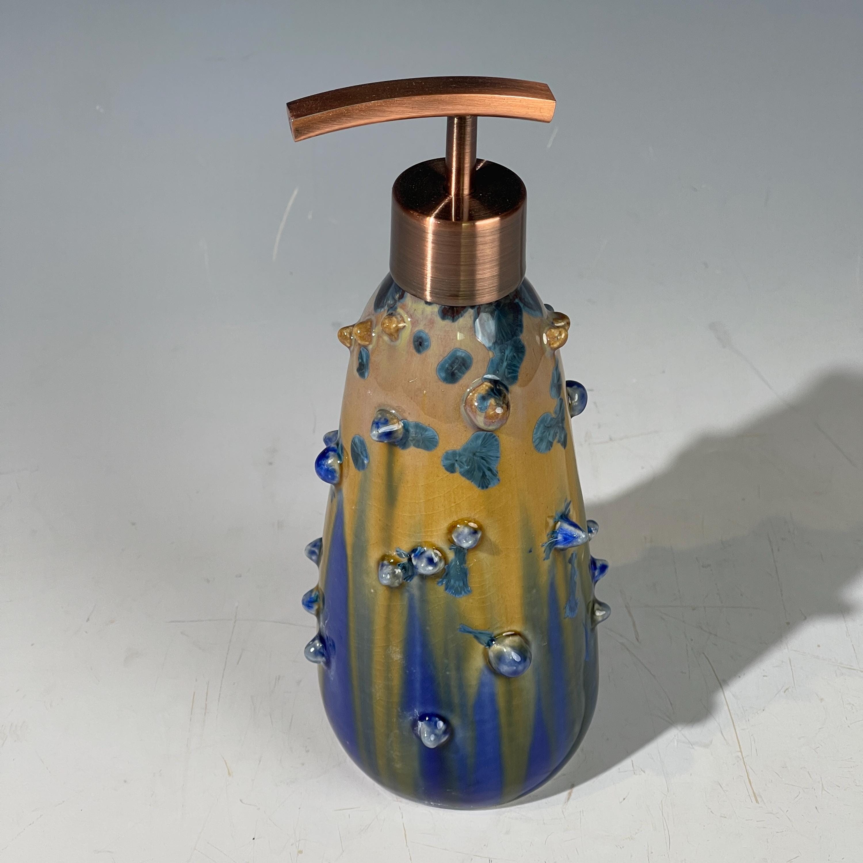 A refractive spiny orange dreams of blue soap pump soap or lotion dispenser
