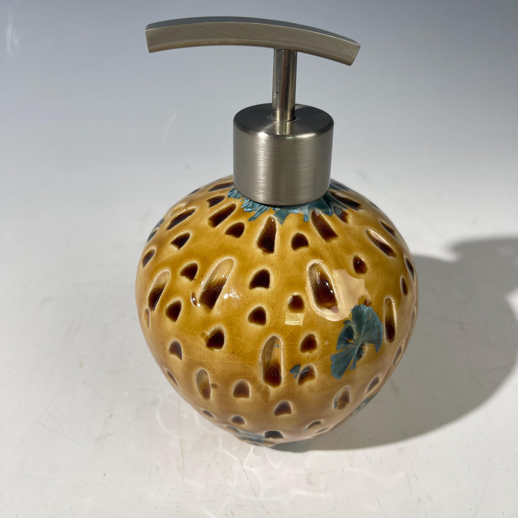 Soap and lotion pump sculptural crystalline golden  metropolis high rise window.