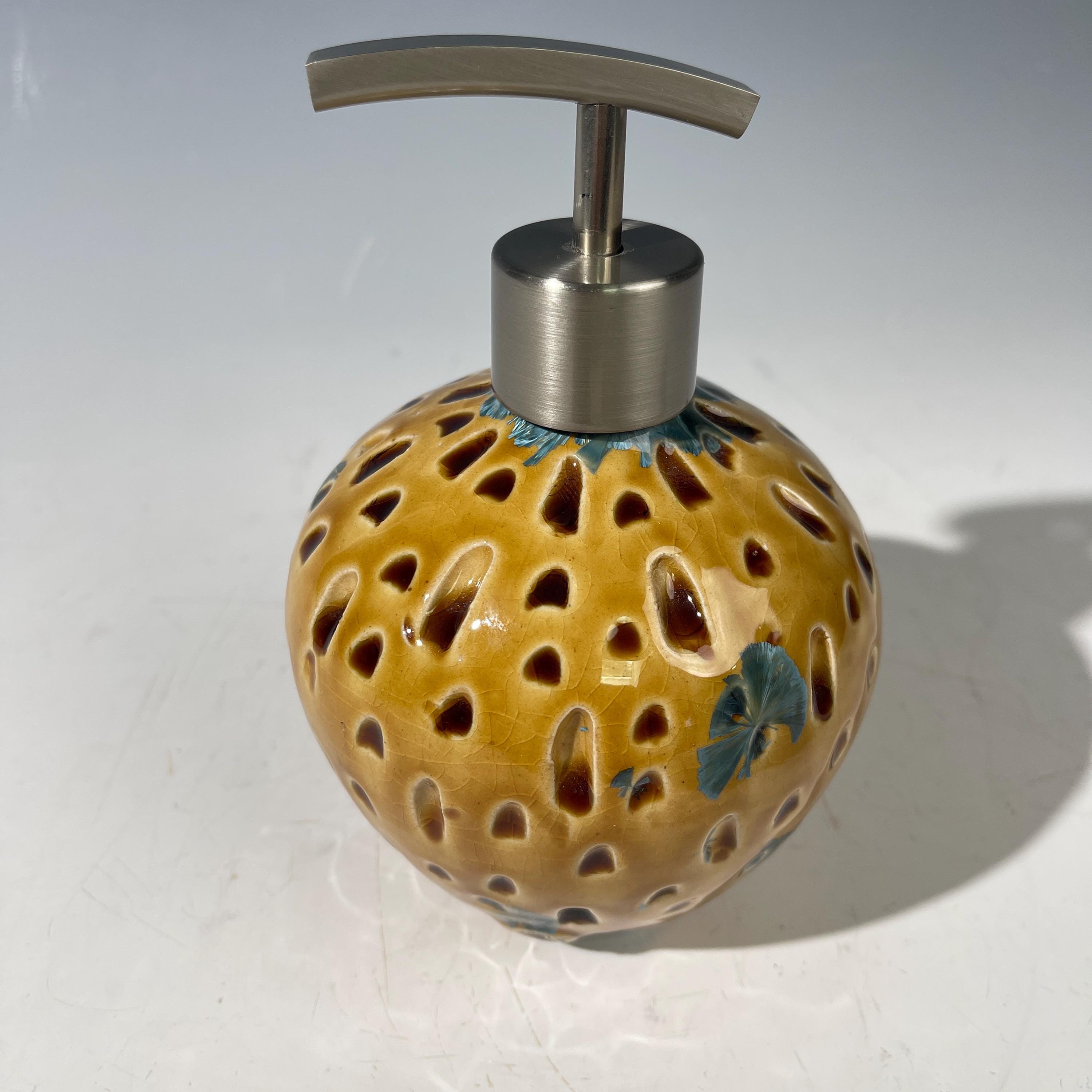 Soap and lotion pump sculptural crystalline golden  metropolis high rise window.