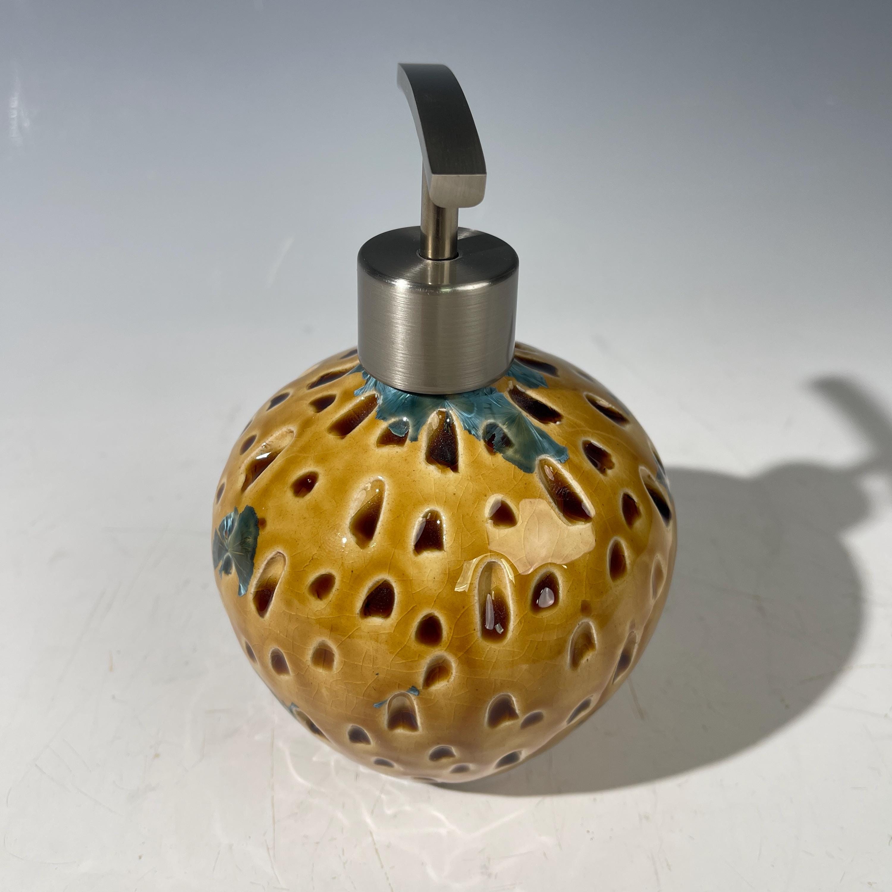 Soap and lotion pump sculptural crystalline golden  metropolis high rise window.