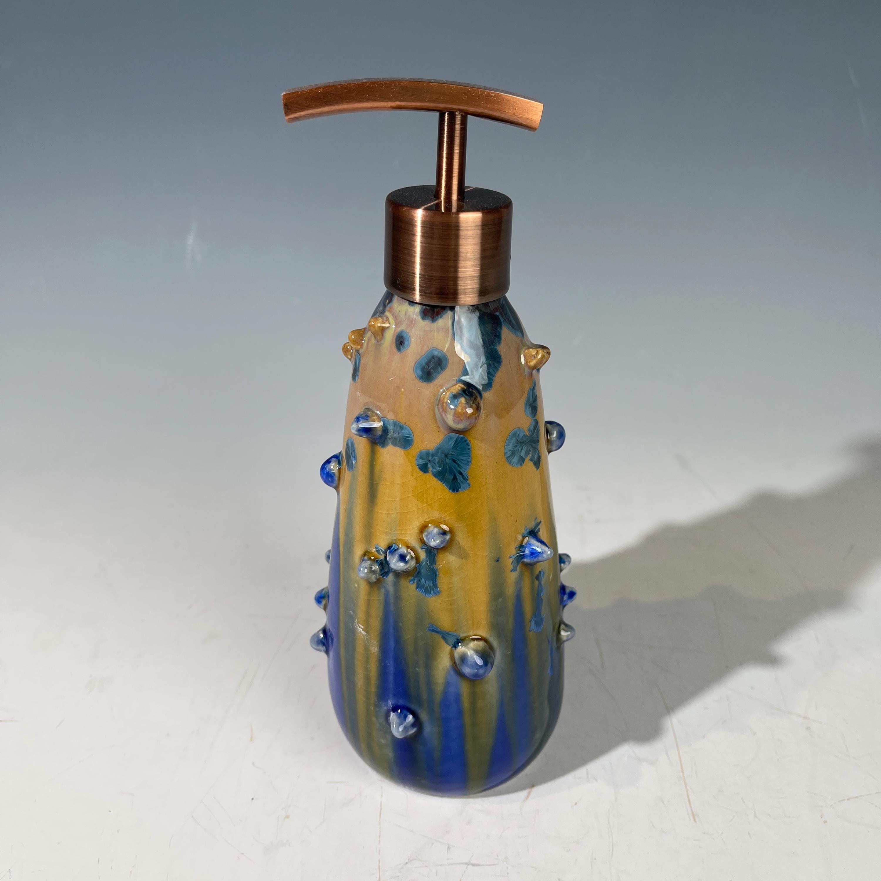 A refractive spiny orange dreams of blue soap pump soap or lotion dispenser
