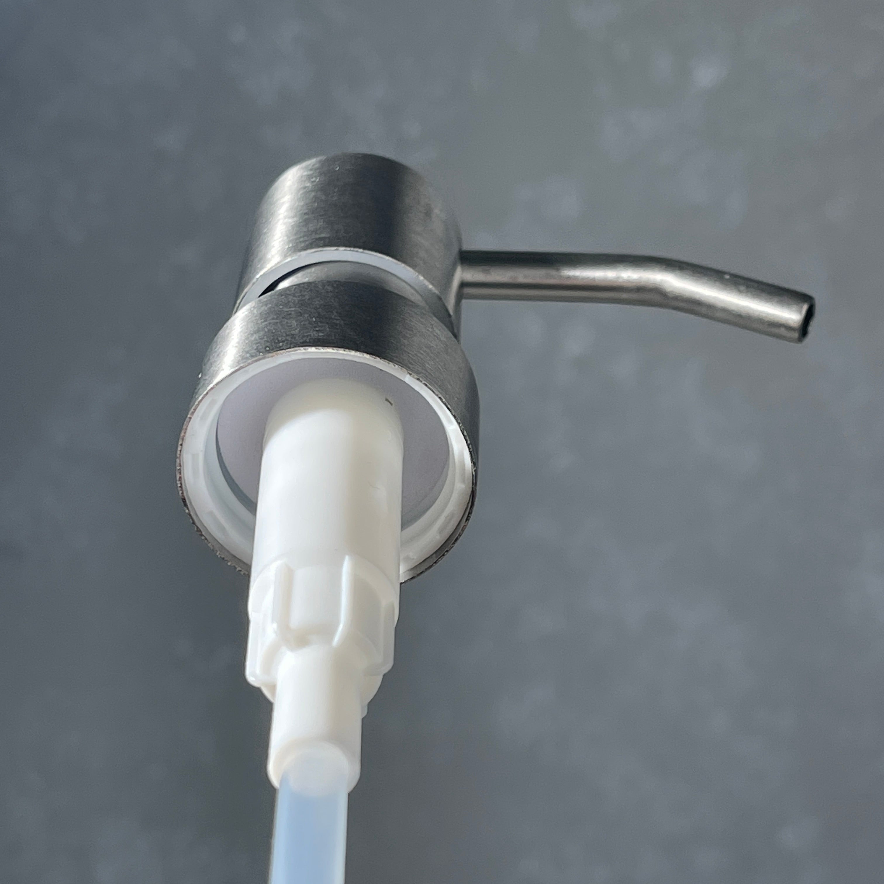 Stainless steel  ez pleaser soap dispenser on a gradiant background