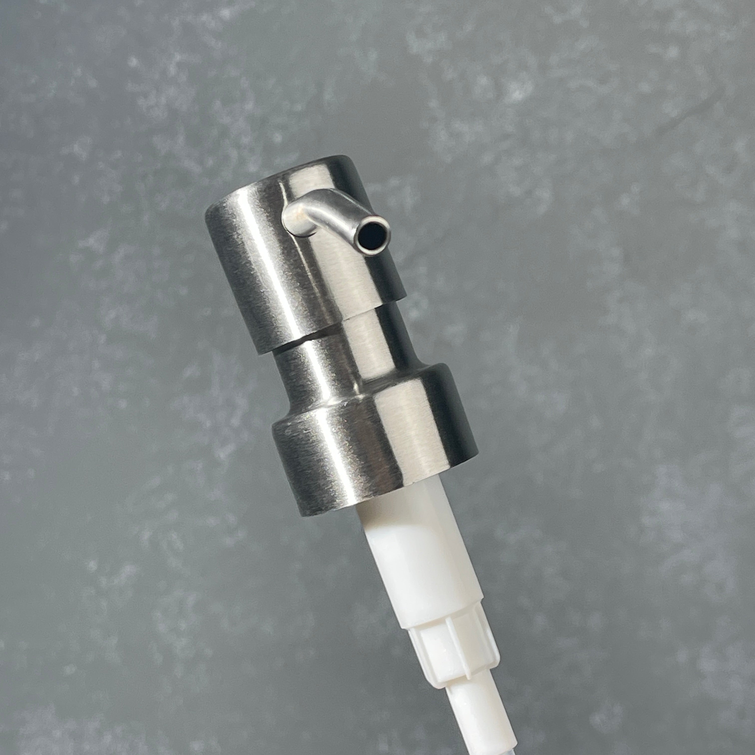 Stainless steel  ez pleaser soap dispenser on a gradiant background