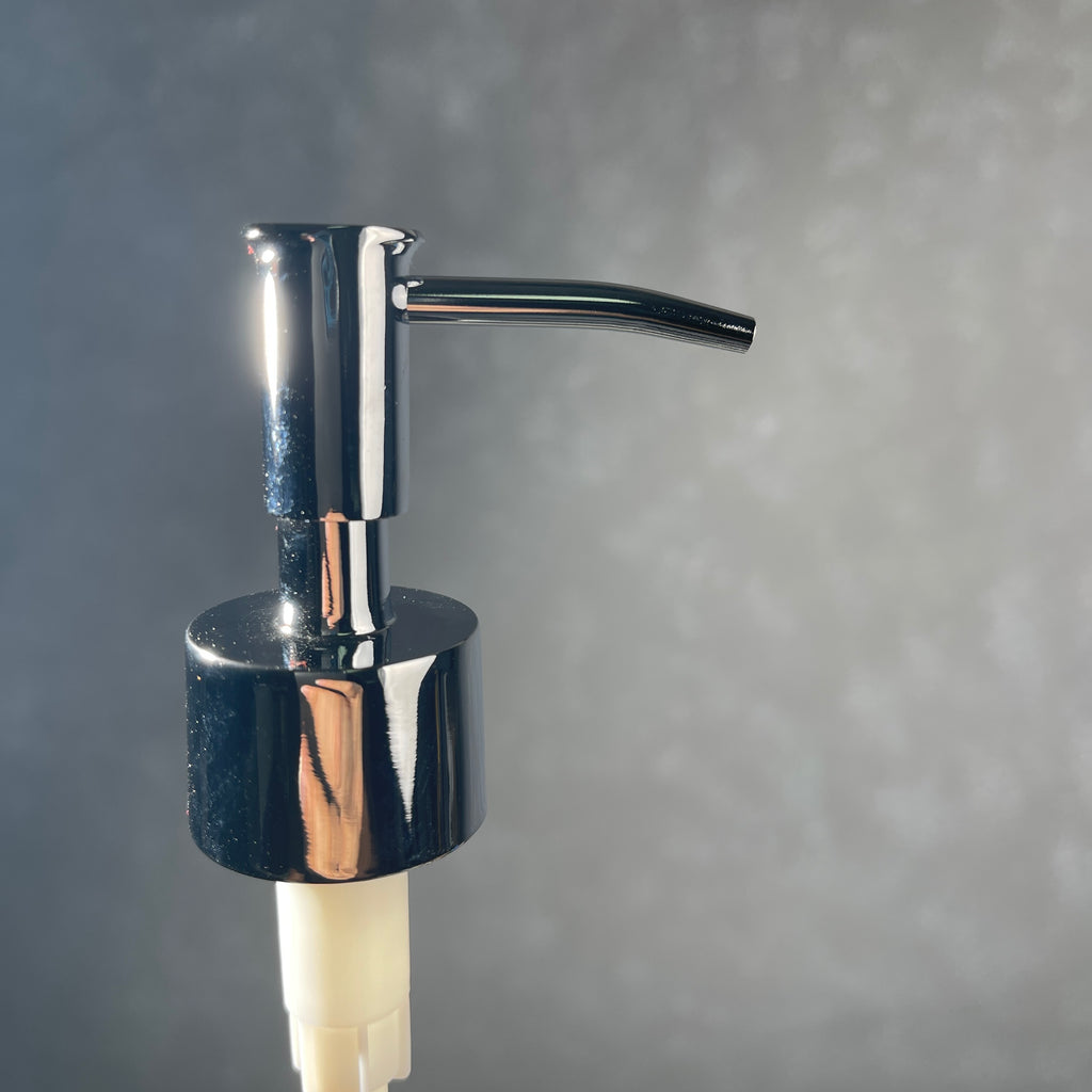 Chrome soap dispenser on a gray background