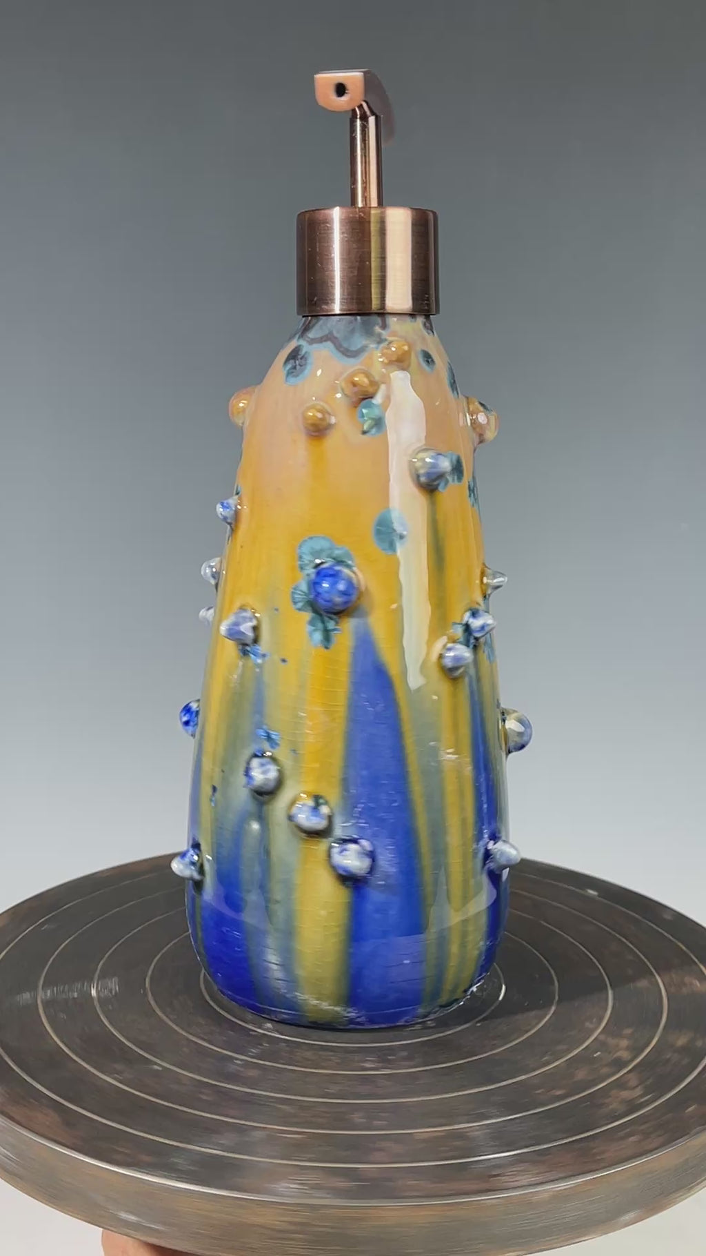 A refractive spiny orange dreams of blue soap pump soap or lotion dispenser