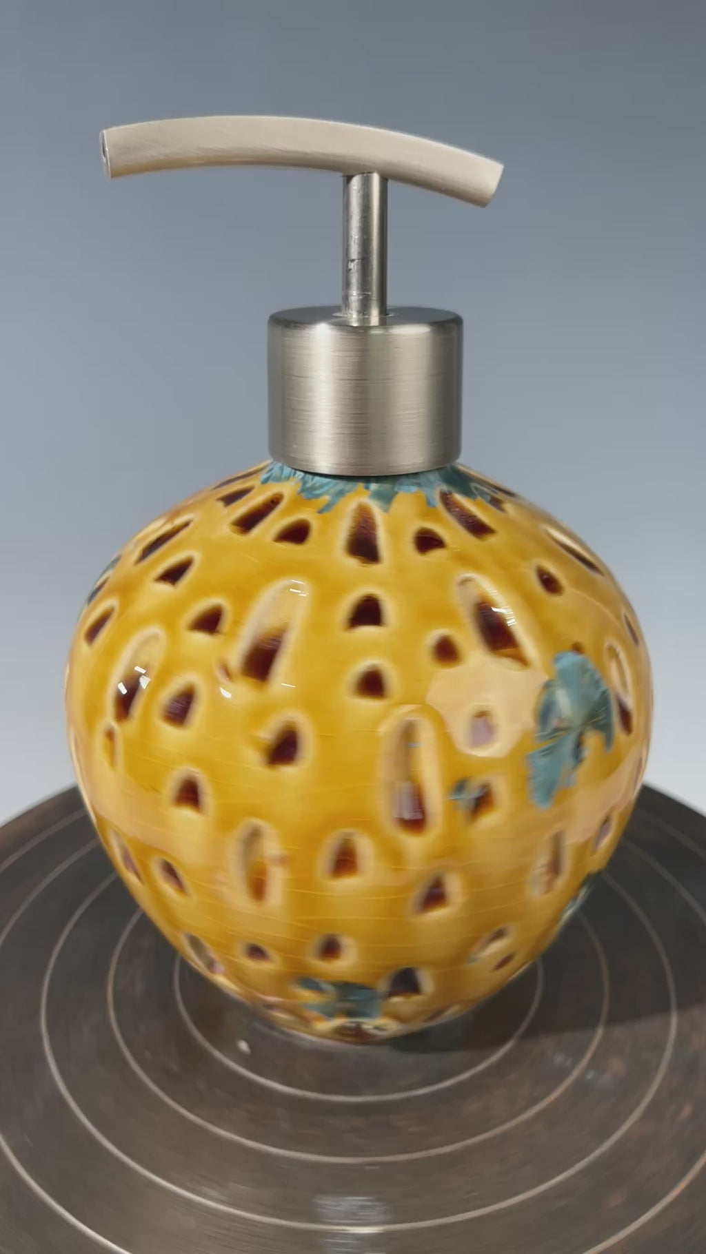 Soap and lotion pump sculptural crystalline golden  metropolis high rise window.
