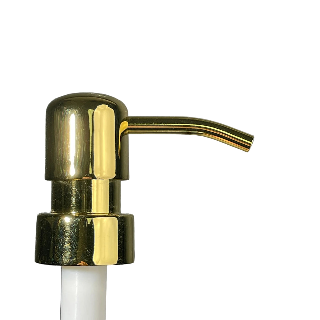 Gold soap dispenser on a gray background