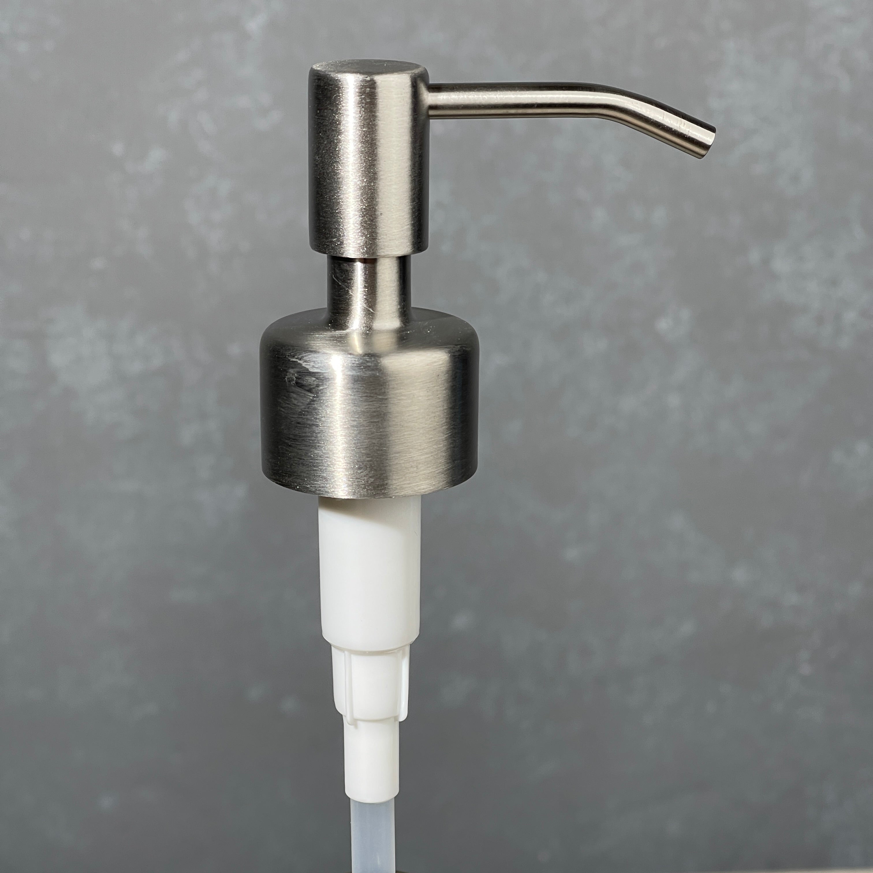 304 stainless  soap dispenser on a gray background